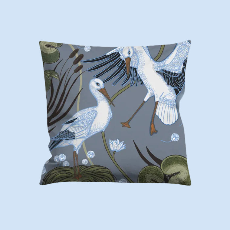 Decorative pillow with artistic stork design on a gray background